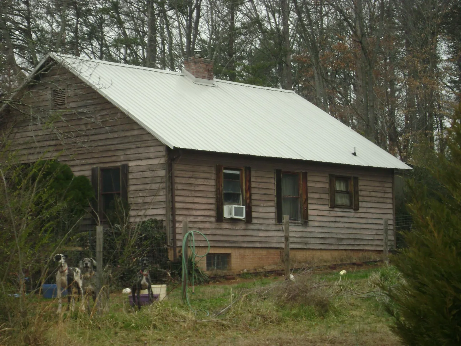 White metal roof on an old wood sided farmhouse, from a Metal Roof Installation job in Baltimore